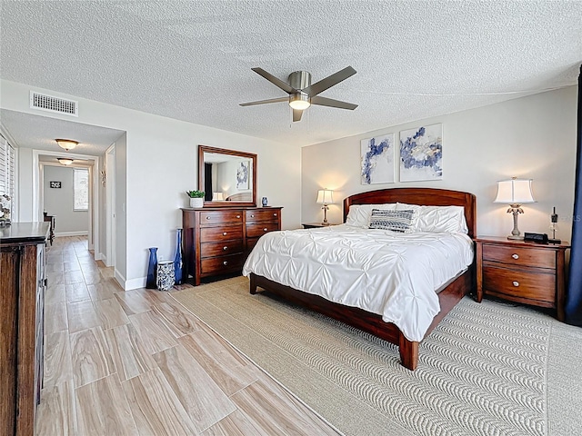 1581 Gulf Blvd Unit 102N, Clearwater Beach, FL 33767 - bedroom featuring a textured ceiling, ceiling fan, and baseboards