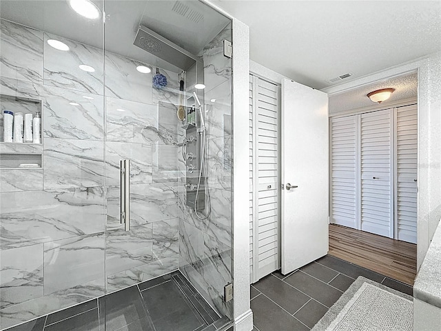 1581 Gulf Blvd Unit 102N, Clearwater Beach, FL 33767 - bathroom with a closet and a marble finish shower