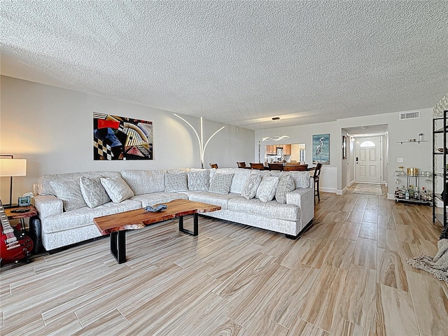 1581 Gulf Blvd Unit 102N, Clearwater Beach, FL 33767 - living area featuring light wood finished floors and a textured ceiling