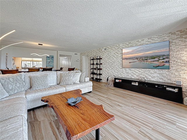 1581 Gulf Blvd Unit 102N, Clearwater Beach, FL 33767 - living room featuring a textured ceiling