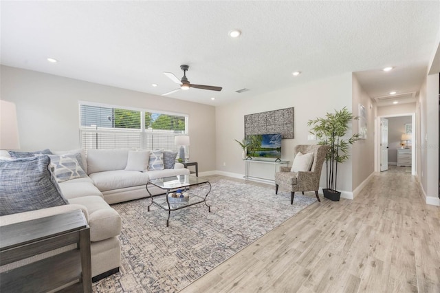living room featuring baseboards, light wood-type flooring, recessed lighting, and a ceiling fan