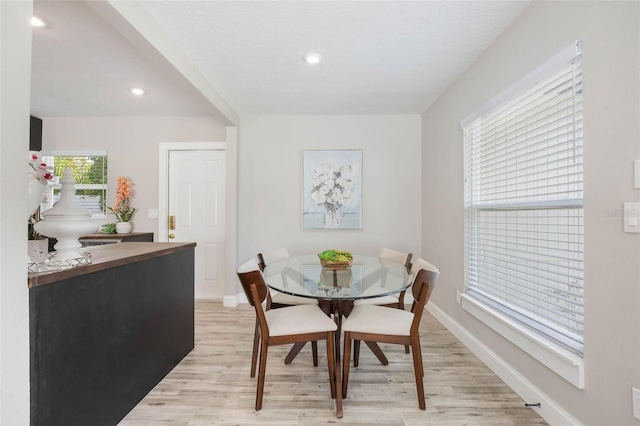 dining space with baseboards, light wood-style floors, and recessed lighting