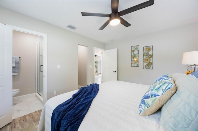 bedroom featuring a ceiling fan, ensuite bathroom, marble finish floor, baseboards, and visible vents