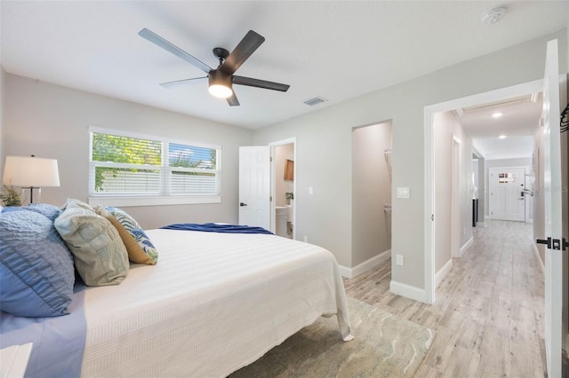 bedroom with baseboards, visible vents, light wood-style flooring, and ceiling fan