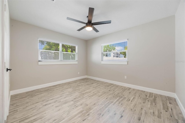 unfurnished room featuring baseboards, ceiling fan, and light wood-type flooring