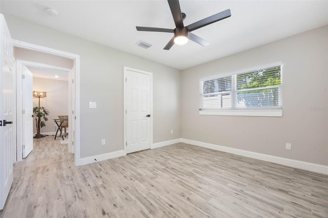 unfurnished bedroom with baseboards, ceiling fan, visible vents, and light wood-style floors