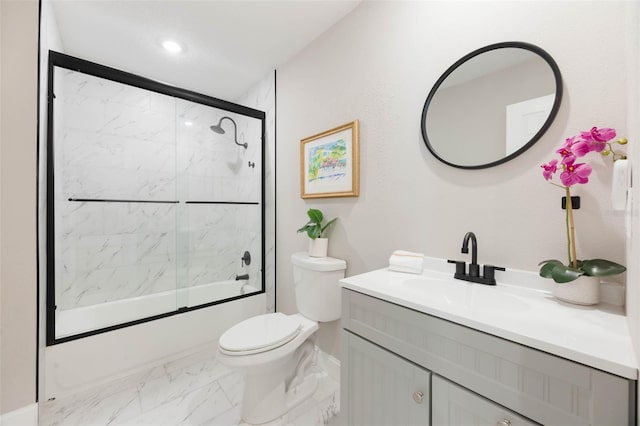 bathroom featuring marble finish floor, toilet, shower / bath combination with glass door, and vanity