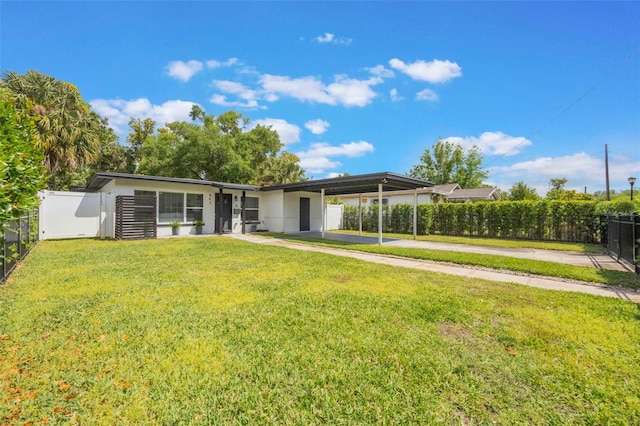 view of front of home with an attached carport, driveway, fence, and a front lawn