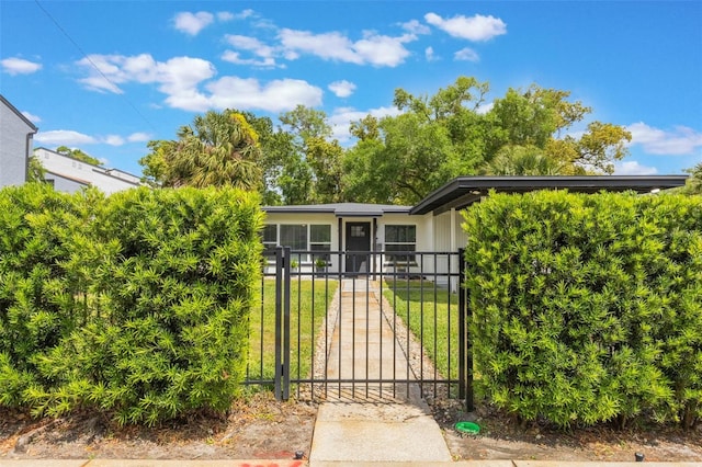 view of gate with a lawn and a fenced front yard