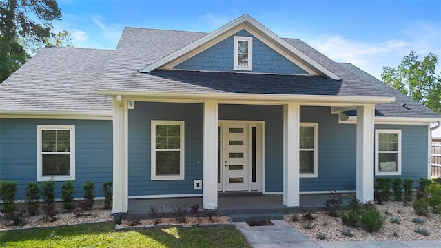 view of front of house with a porch and roof with shingles