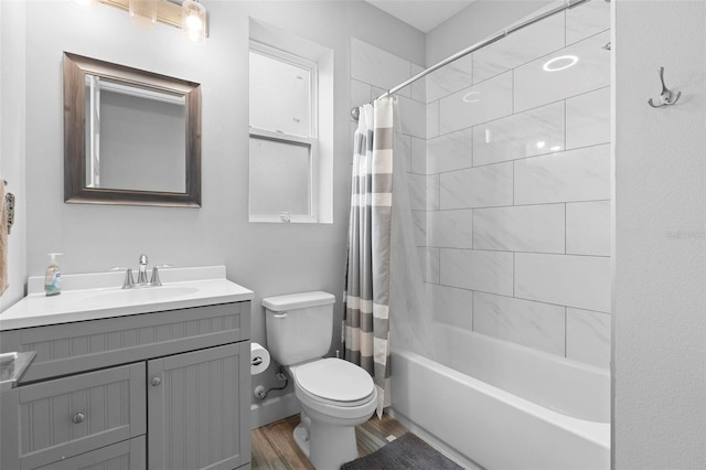 bathroom featuring shower / bathtub combination with curtain, wood finished floors, toilet, and vanity