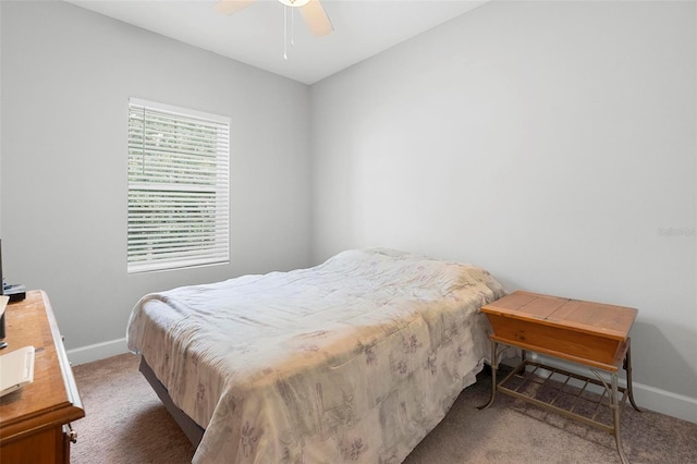 carpeted bedroom with baseboards and a ceiling fan