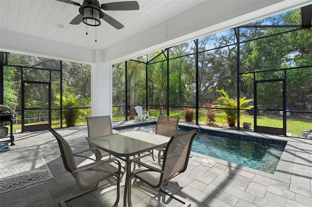 sunroom / solarium featuring a wealth of natural light and a ceiling fan