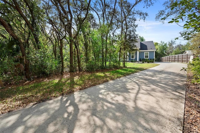 exterior space featuring fence and concrete driveway