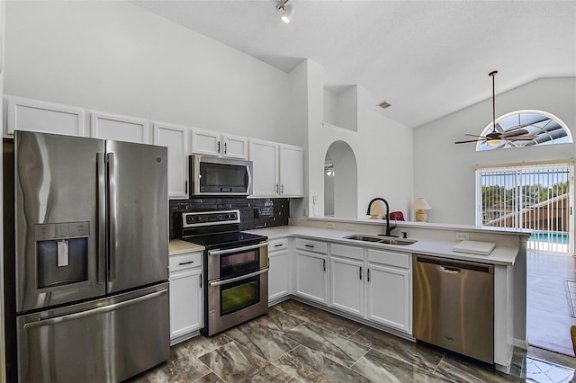 7606 Fordham Creek Ln, Orlando, FL 32818 - kitchen with stainless steel appliances, a peninsula, light countertops, ceiling fan, and white cabinetry