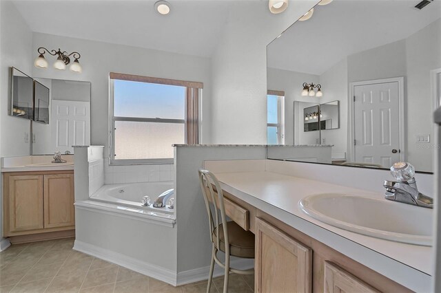 7606 Fordham Creek Ln, Orlando, FL 32818 - full bathroom with healthy amount of natural light, a garden tub, two vanities, and tile patterned flooring