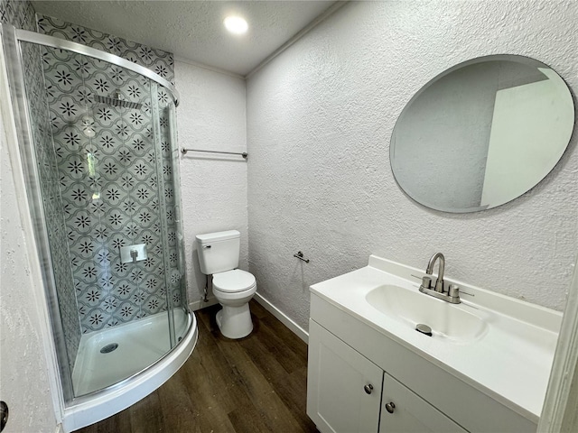 full bath with a stall shower, a textured wall, a textured ceiling, toilet, and wood finished floors