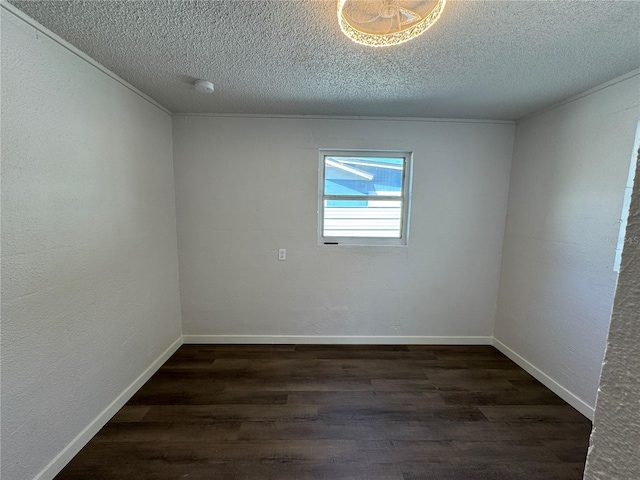 empty room with dark wood-style flooring, baseboards, and a textured ceiling