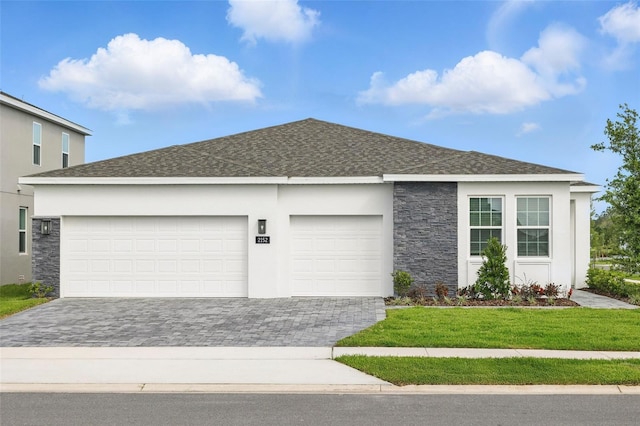 2152 Rock Maple Bnd, Kissimmee, FL 34746 - ranch-style house featuring stone siding, decorative driveway, an attached garage, and roof with shingles