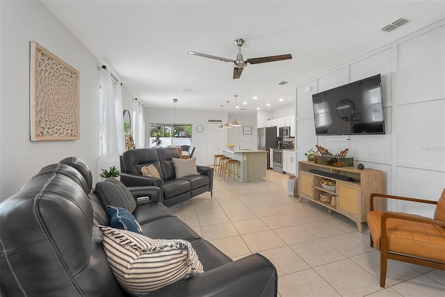 living area featuring recessed lighting, light tile patterned floors, visible vents, and ceiling fan