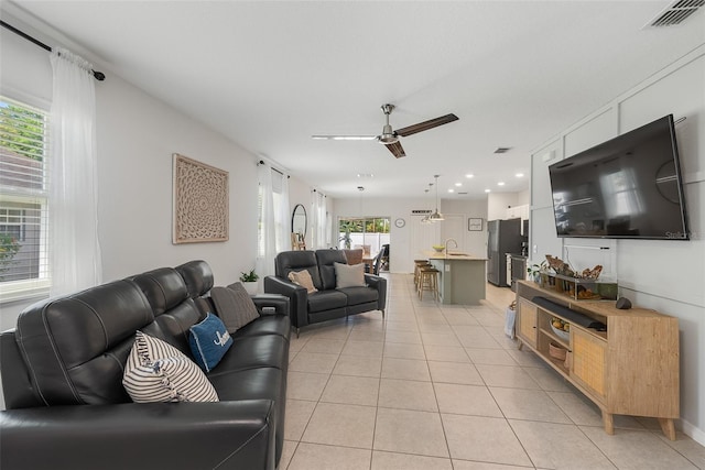 living area with visible vents, a ceiling fan, light tile patterned flooring, and recessed lighting