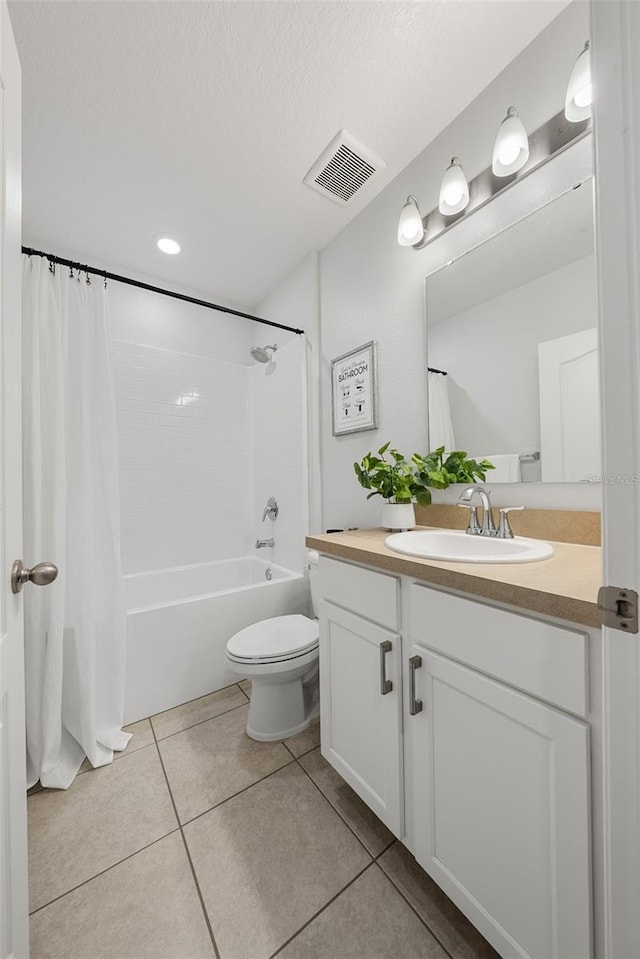 full bathroom with vanity, shower / tub combo with curtain, tile patterned floors, toilet, and visible vents