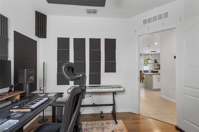 home office with wood finished floors, baseboards, and visible vents