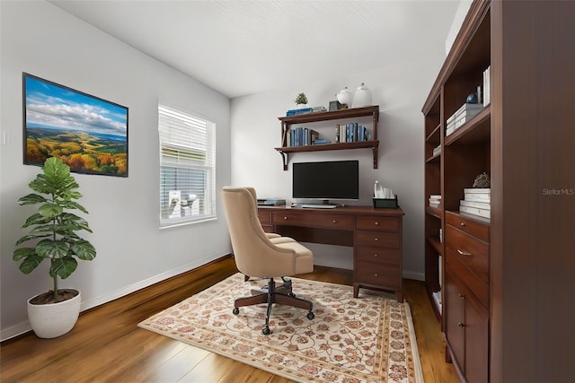 office with wood finished floors and baseboards