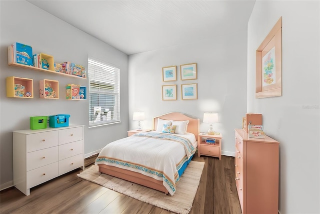 bedroom featuring baseboards and wood finished floors