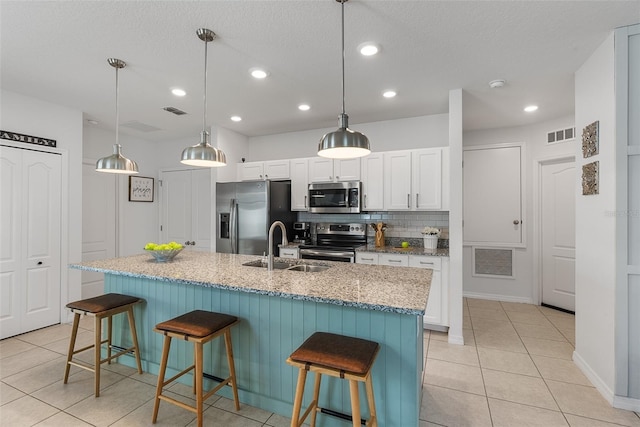 kitchen with a sink, visible vents, appliances with stainless steel finishes, and light tile patterned flooring
