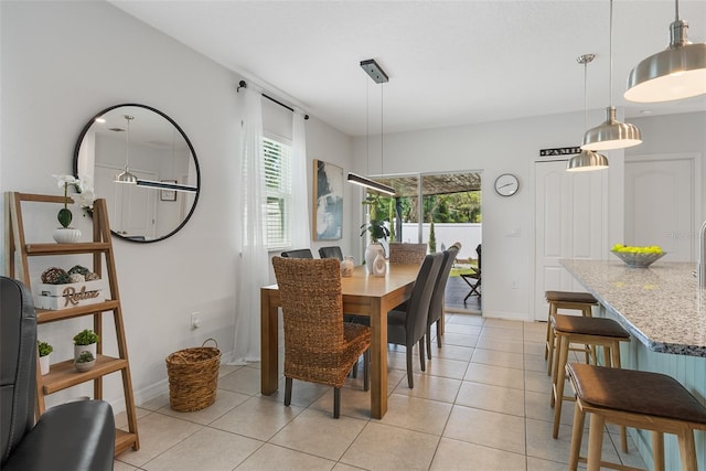 dining area featuring light tile patterned floors and baseboards