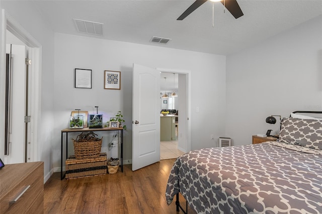 bedroom featuring visible vents, baseboards, and wood finished floors