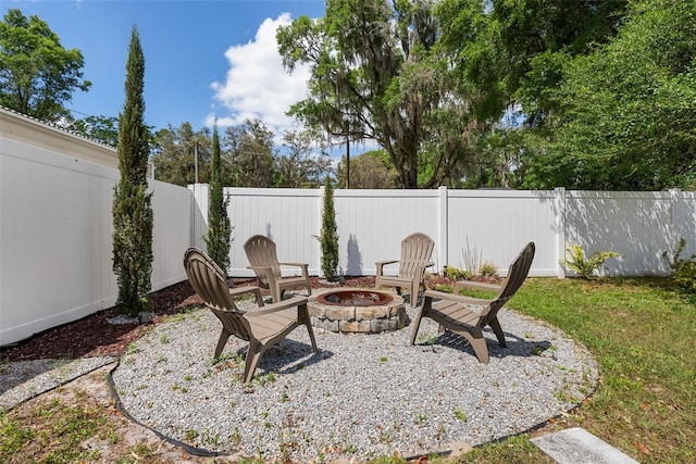 view of yard with a fire pit and a fenced backyard