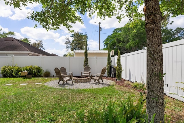 view of yard with a patio, a fenced backyard, and an outdoor fire pit