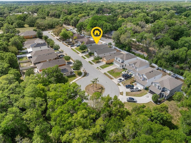 bird's eye view featuring a wooded view and a residential view