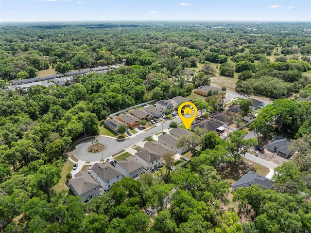 bird's eye view featuring a wooded view and a residential view