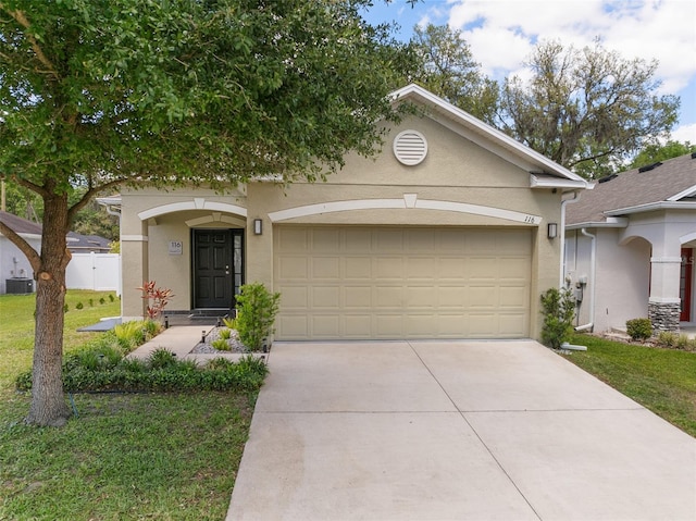 view of front of home featuring cooling unit, stucco siding, a front lawn, an attached garage, and concrete driveway