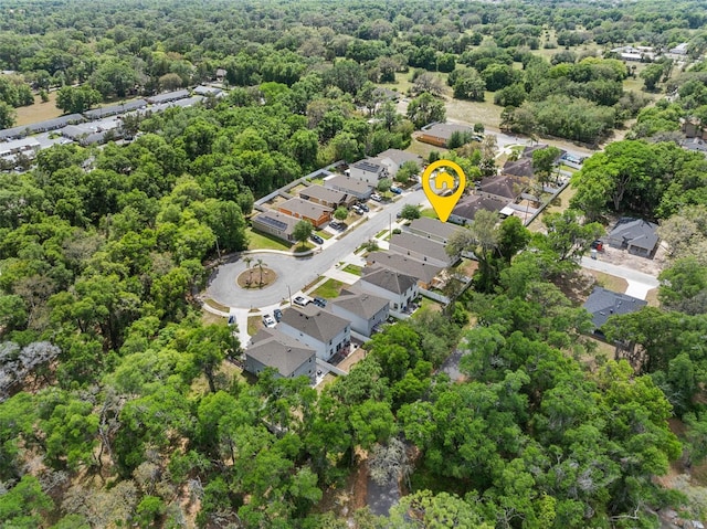 birds eye view of property with a forest view and a residential view
