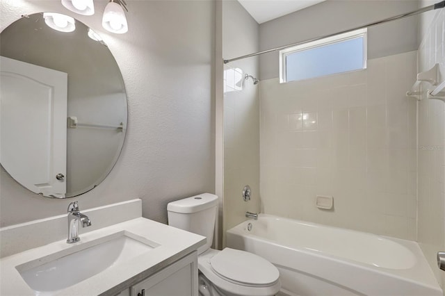 full bath featuring a textured wall, toilet, vanity, and washtub / shower combination