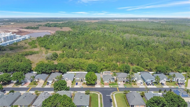 birds eye view of property with a residential view and a view of trees