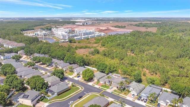 bird's eye view with a residential view, a water view, and a view of trees