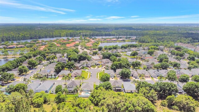 birds eye view of property with a water view, a forest view, and a residential view