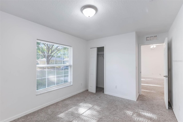205 Lori Ct, Umatilla, FL 32784 - unfurnished bedroom featuring visible vents, baseboards, a closet, carpet, and a textured ceiling
