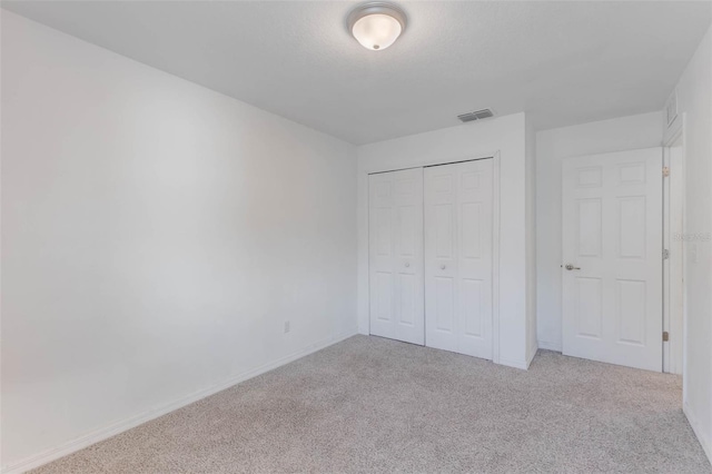 205 Lori Ct, Umatilla, FL 32784 - unfurnished bedroom with a closet, carpet flooring, baseboards, and visible vents