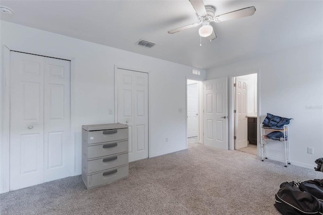 205 Lori Ct, Umatilla, FL 32784 - unfurnished bedroom with visible vents, multiple closets, ceiling fan, and carpet floors