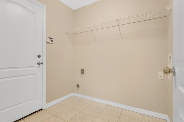 1556 Sherbourne St, Winter Garden, FL 34787 - washroom with light tile patterned floors, hookup for an electric dryer, baseboards, and laundry area