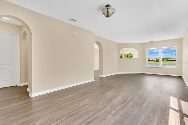 1556 Sherbourne St, Winter Garden, FL 34787 - spare room featuring baseboards, visible vents, wood finished floors, and arched walkways