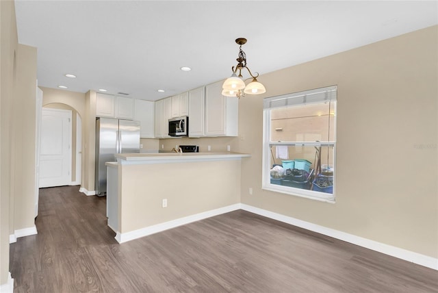 1556 Sherbourne St, Winter Garden, FL 34787 - kitchen with baseboards, white cabinetry, stainless steel appliances, and arched walkways