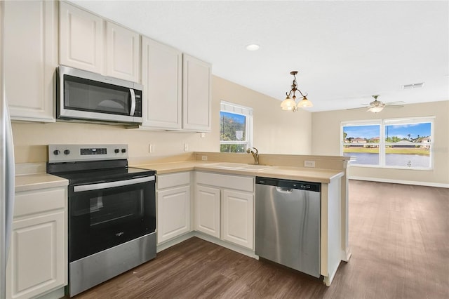 1556 Sherbourne St, Winter Garden, FL 34787 - kitchen with a sink, white cabinets, appliances with stainless steel finishes, and a peninsula