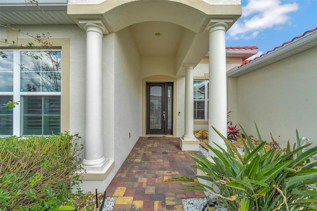 entrance to property featuring stucco siding